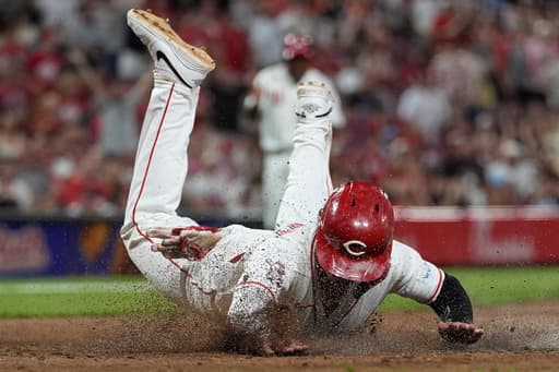 Reds score twice in 8th on wild pitches to beat Athletics 5-4