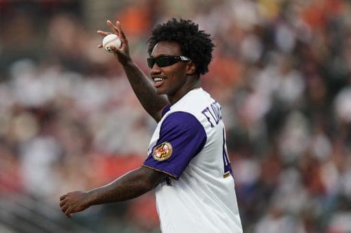 Baltimore Ravens NFL football wide receiver Zay Flowers waves to the crowd before throwing out a ceremonial first pitch ahead of a baseball game between the Baltimore Orioles and the Boston Red Sox, Saturday, Sept. 5, 2026, in Baltimore. (AP Photo/Stephanie Scarbrough) (AP Photo/Stephanie Scarbrough)