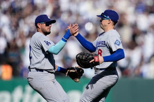Los Angeles Dodgers third baseman Miguel Rojas, left, celebrates with first baseman Enrique Hernández after a baseball game against the San Francisco Giants, Saturday, Sept. 26, 2026, in San Francisco. (AP Photo/Jeff Chiu) (AP Photo/Jeff Chiu)