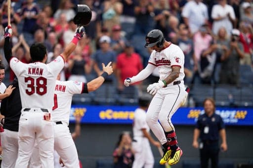 Cleveland Guardians' Brayan Rocchio, right, jumps onto home plate after hitting the game winning home run in the ninth inning of the first baseball game of a split doubleheader against the Detroit Tigers in Cleveland, Friday, Sept. 4, 2026. (AP Photo/Sue Ogrocki) (AP Photo/Sue Ogrocki)