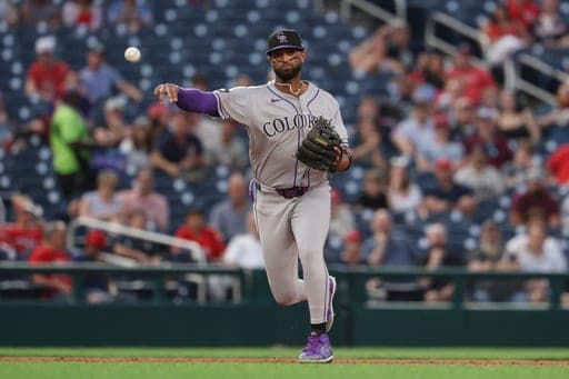 Colorado Rockies third baseman Willi Castro throws to first base for an out on a ball hit by Washington Nationals' Dylan Crews during the third inning of baseball game in Washington, Monday, Aug. 24, 2026. (AP Photo/Terrance Williams) (AP Photo/Terrance Williams)