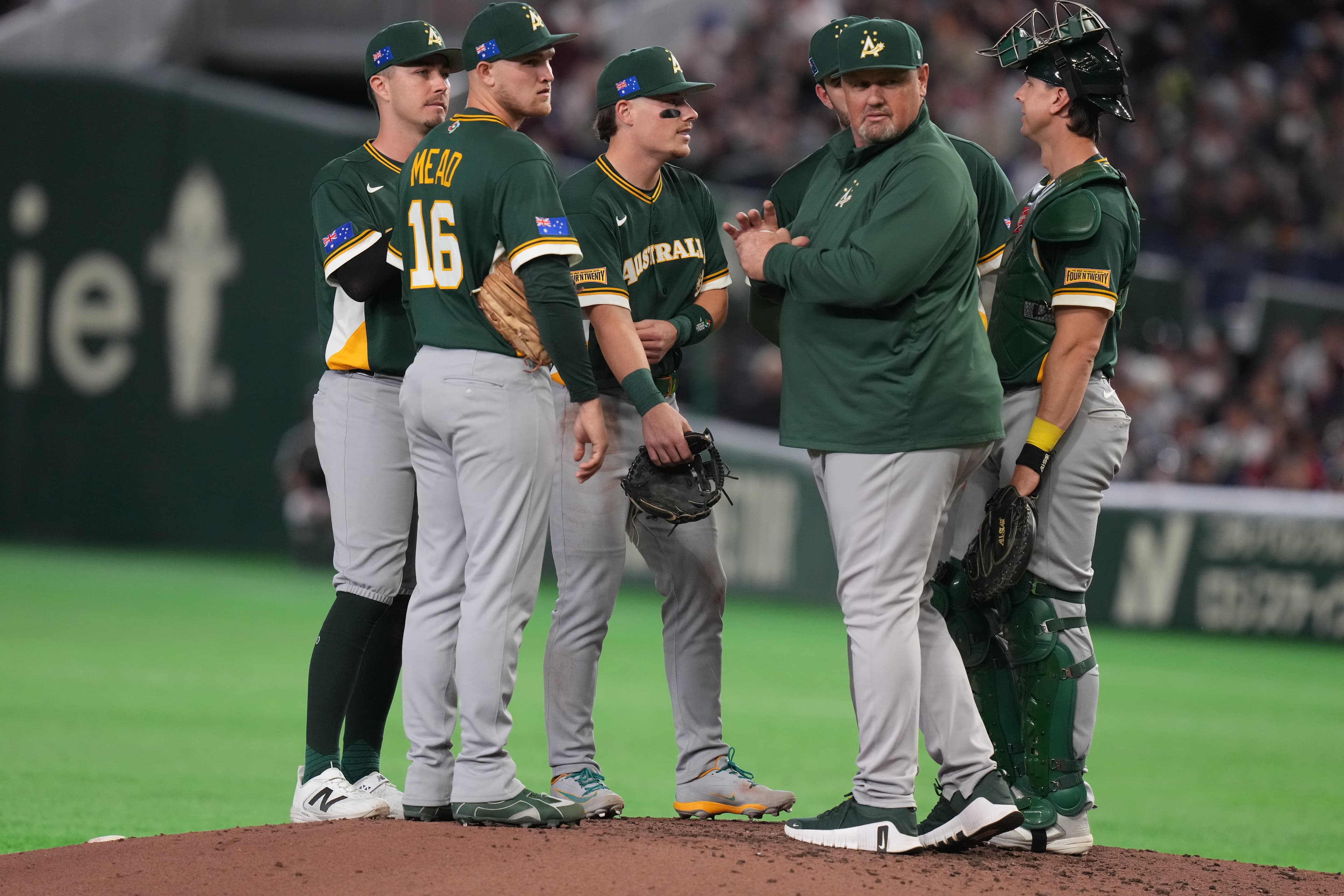 Australia's manager Dave Nilsson, second right, visits the pitchers mound during the sixth inning of a World Baseball Classic game between Japan and Australia on Sunday, March 8, 2026 in Tokyo. (AP Photo/Eugene Hoshiko)