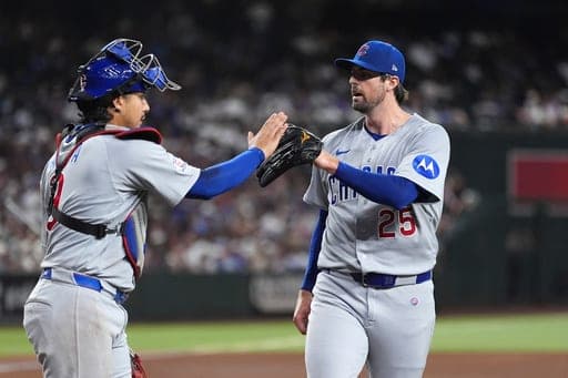 Chicago Cubs pitcher Clay Holmes (25) celebrates retiring the Arizona Diamondbacks with Cubs catcher Miguel Amaya, left, during the sixth inning of a baseball game, Tuesday, Aug. 25, 2026, in Phoenix. (AP Photo/Ross D. Franklin) (AP Photo/Ross D. Franklin)