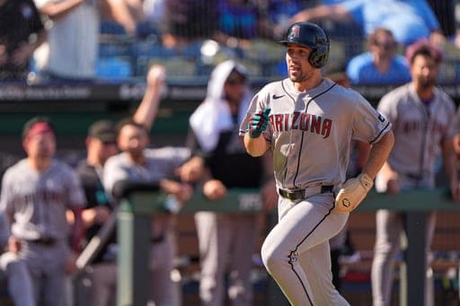 Arizona Diamondbacks' Ryan Waldschmidt runs home to score on a two-run double hit by Geraldo Perdomo during the 10th inning of a baseball game against the Kansas City Royals, Monday, Sept. 7, 2026, in Kansas City, Mo. (AP Photo/Charlie Riedel) (AP Photo/Charlie Riedel)