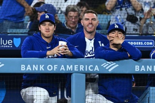 Los Angeles Dodgers' Shohei Ohtani, left, looks on during the ninth inning of a baseball game against the Washington Nationals, Friday, Sept. 4, 2026, in Los Angeles. (AP Photo/William Liang) (AP Photo/William Liang)