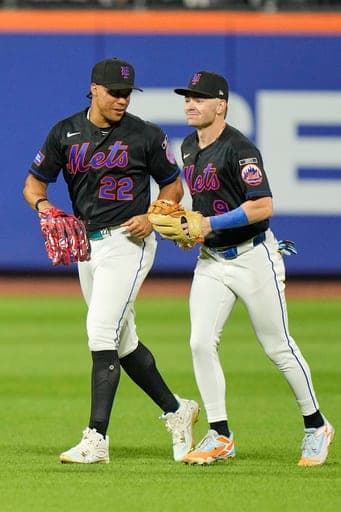 New York Mets outfielders Juan Soto, left, and A.J. Ewing celebrate after a baseball game against the Philadelphia Phillies, Friday, Sept. 18, 2026, in New York. (AP Photo/Seth Wenig) (AP Photo/Seth Wenig)