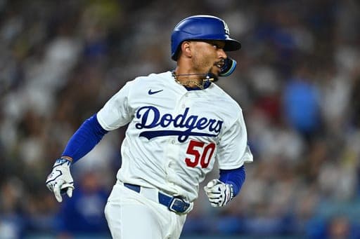 Los Angeles Dodgers' Mookie Betts runs after hitting an RBI single during the third inning of a baseball game against the Washington Nationals, Friday, Sept. 4, 2026, in Los Angeles. (AP Photo/William Liang) (AP Photo/William Liang)
