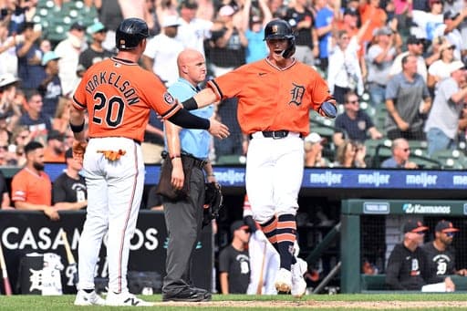 Detroit Tigers' Ben Malgeri, right, scores a run and is congratulated by Spencer Torkelson during the eighth inning of a baseball game against the Colorado Rockies, Saturday, Sept. 12, 2026, in Detroit. (AP Photo/Jose Juarez)wld (AP Photo/Jose Juarez)