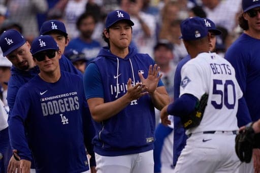Los Angeles Dodgers' Mookie Betts, right, is congratulated by Shohei Ohtani, center, and Yoshinobu Yamamoto after the Dodgers defeated the San Francisco Giants in a baseball game Sunday, Sept. 20, 2026, in Los Angeles. (AP Photo/Mark J. Terrill) (AP Photo/Mark J. Terrill)