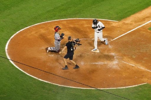 Chicago White Sox's Miguel Vargas touches home plate after hitting a home run during the ninth inning in Game 4 of an American League Division Series baseball game in Chicago, Thursday, Oct. 8, 2026. (AP Photo/Melissa Tamez) (AP Photo/Melissa Tamez)