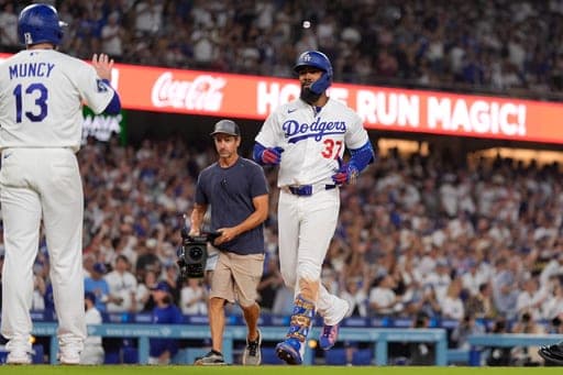 Los Angeles Dodgers' Teoscar Hernández, right, is congratulated by Max Muncy after hitting a three-run home run during the sixth inning of a baseball game against the Cincinnati Reds, Monday, Sept. 7, 2026, in Los Angeles. (AP Photo/Mark J. Terrill) (AP Photo/Mark J. Terrill)