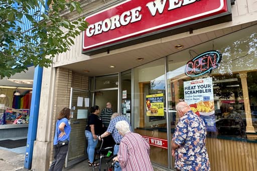 Brewers fans line up to grab free burgers as part of local fast-food chain’s promotion