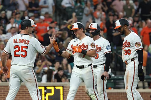 Holliday hits grand slam and Young pitches Orioles past Mariners 7-2 to stop 4-game slide