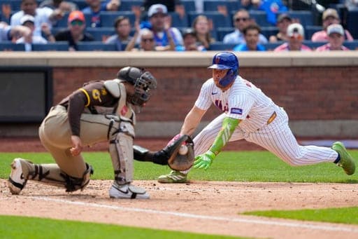 New York Mets designated hitter Francisco Alvarez slides into home plate during the seventh inning of a baseball game against the San Diego Padres, Wednesday, Aug. 19, 2026, in New York. (AP Photo/Yuki Iwamura) (AP Photo/Yuki Iwamura)