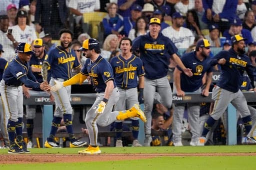 Milwaukee Brewers center fielder Garrett Mitchell (5) runs past teammates after hitting a solo home run during the seventh inning of Game 3 of baseball's National League Championship Series between the Milwaukee Brewers and the Los Angeles Dodgers, Wednesday, Oct. 14, 2026, in Los Angeles. (AP Photo/Mark J. Terrill) (AP Photo/Mark J. Terrill)