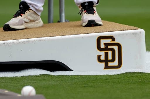 FILE - Detailed view of a San Diego Padres logo on a pitching mound during batting practice prior to a baseball game between the Padres and Boston Red Sox, May 20, 2023, in San Diego. (AP Photo/Brandon Sloter, File) (AP Photo/Brandon Sloter)