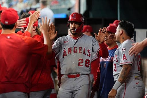 Los Angeles Angels' Jose Siri (28) celebrates with the team after scoring on a Denzer Guzman double in the 10th inning of a baseball game against the Texas Rangers Friday, Aug. 21, 2026, in Arlington, Texas. (AP Photo/Tony Gutierrez) (AP Photo/Tony Gutierrez)