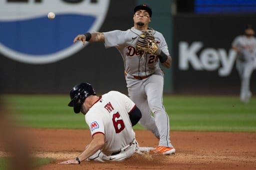 Detroit Tigers' Javier Baez forces Cleveland Guardians' David Fry at second base and throws to first to complete a double play during the seventh inning of a baseball game, Saturday, Sept. 5, 2026, in Cleveland. (AP Photo/Phil Long) (AP Photo/Phil Long)
