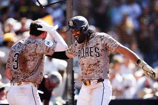 San Diego Padres' Fernando Tatis Jr., right, celebrates with Jackson Merrill (3) after hitting a solo home run against Minnesota Twins in the eighth inning of a baseball game Sunday, Aug. 23, 2026, in San Diego. (AP Photo/Derrick Tuskan) (AP Photo/Derrick Tuskan)