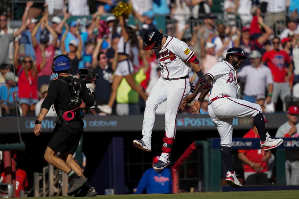 raves third baseman Austin Riley celebrates after hitting a three-run home run in Game 1 of the National League Wild Card Series.