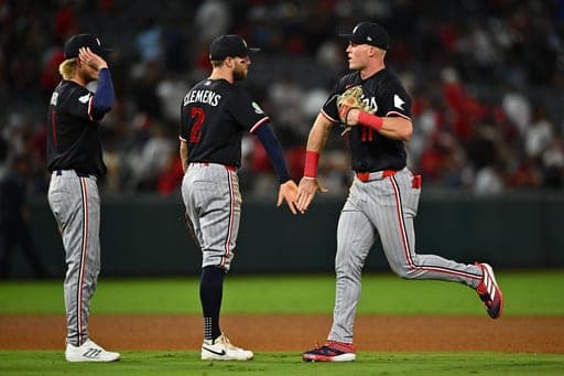 Minnesota Twins' Walker Jenkins, right, is greeted by Kody Clemens (2) after defeating the Los Angeles Angels in a baseball game Friday, Sept. 18, 2026, in Anaheim, Calif. (AP Photo/William Liang) (AP Photo/William Liang)