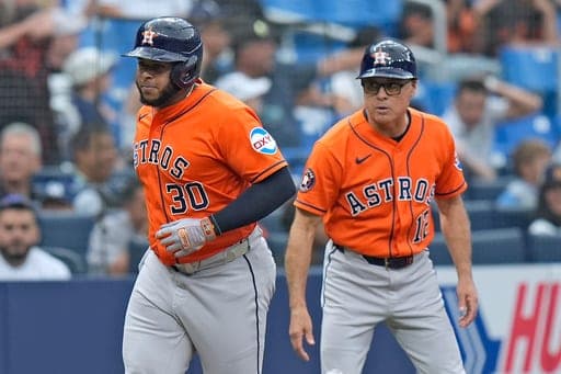 Houston Astros' Nelson Velázquez celebrates with third base coach Tony Perezchica (12) after his solo home run off Tampa Bay Rays pitcher Casey Legumina during the eighth inning of a baseball game Sunday, Sept. 13, 2026, in St. Petersburg, Fla. (AP Photo/Chris O'Meara) (AP Photo/Chris O'Meara)