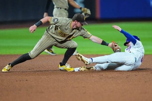 San Diego Padres' Jake Cronenworth, left, tags out New York Mets' Carson Benge at second base during the seventh inning of a baseball game Monday, Aug. 17, 2026, in New York. (AP Photo/Frank Franklin II) (AP Photo/Frank Franklin II)
