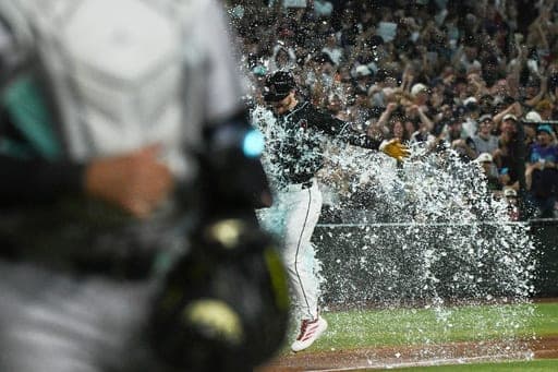 Arizona Diamondbacks' Pavin Smith has Gatorade dumped on him after he scored a game-winning home run during the ninth inning of a baseball game against the New York Yankees, Saturday, Sept. 19, 2026, in Phoenix. (AP Photo/Caitlin O'Hara) (AP Photo/Caitlin O'Hara)