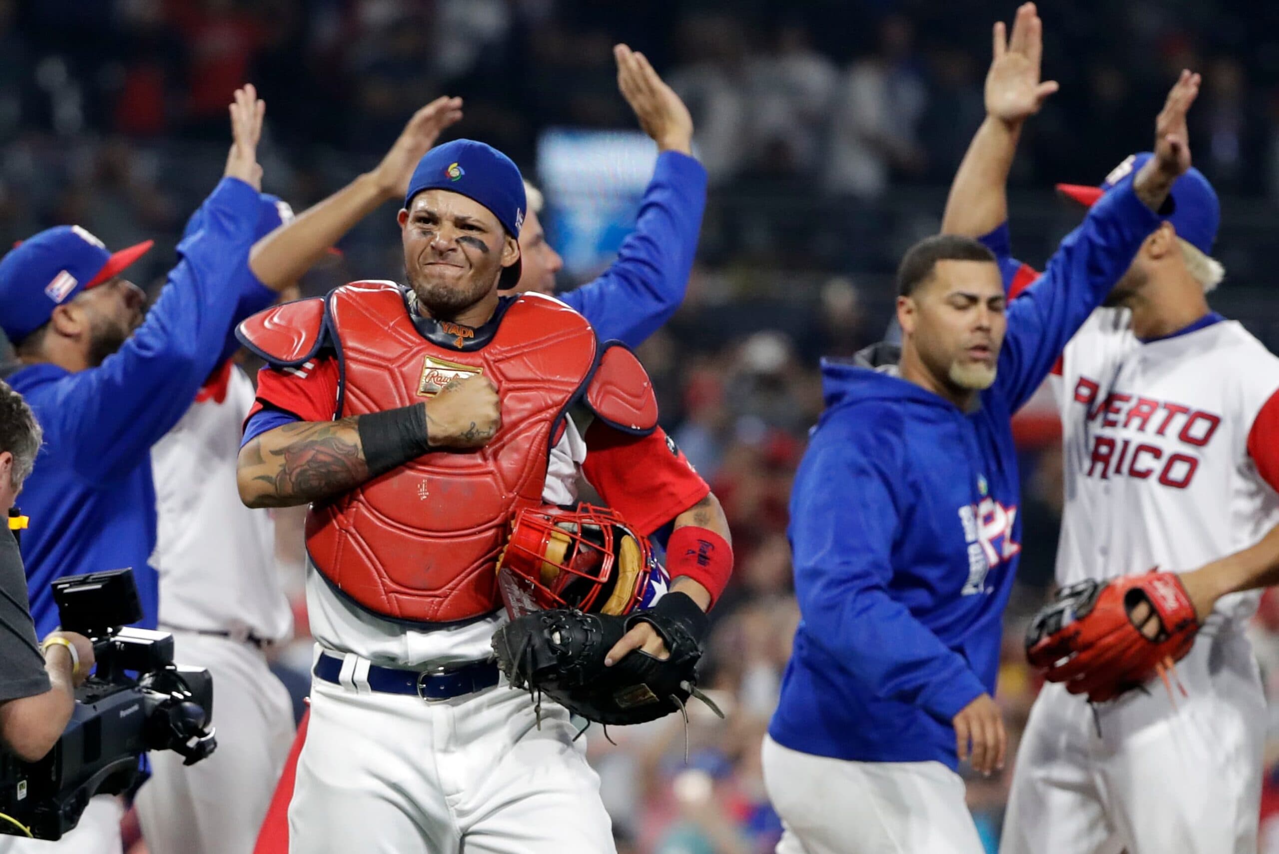 WBC Dominican Republic Puerto Rico Baseball Image ID : 17074176892195 Puerto Rico catcher Yadier Molina, center left, reacts with teammates after defeating the Dominican Republic in a second-round World Baseball Classic game Tuesday, March 14, 2017, in San Diego. Puerto Rico won, 3-1. (AP Photo/Gregory Bull)