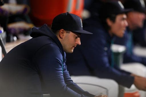 Seattle Mariners designated hitter Dominic Canzone (8) looks on from the dugout during the seventh inning of a baseball game against the Houston Astros, Tuesday, Sept. 22, 2026, in Seattle. (AP Photo/Kevin Ng) (AP Photo/Kevin Ng)