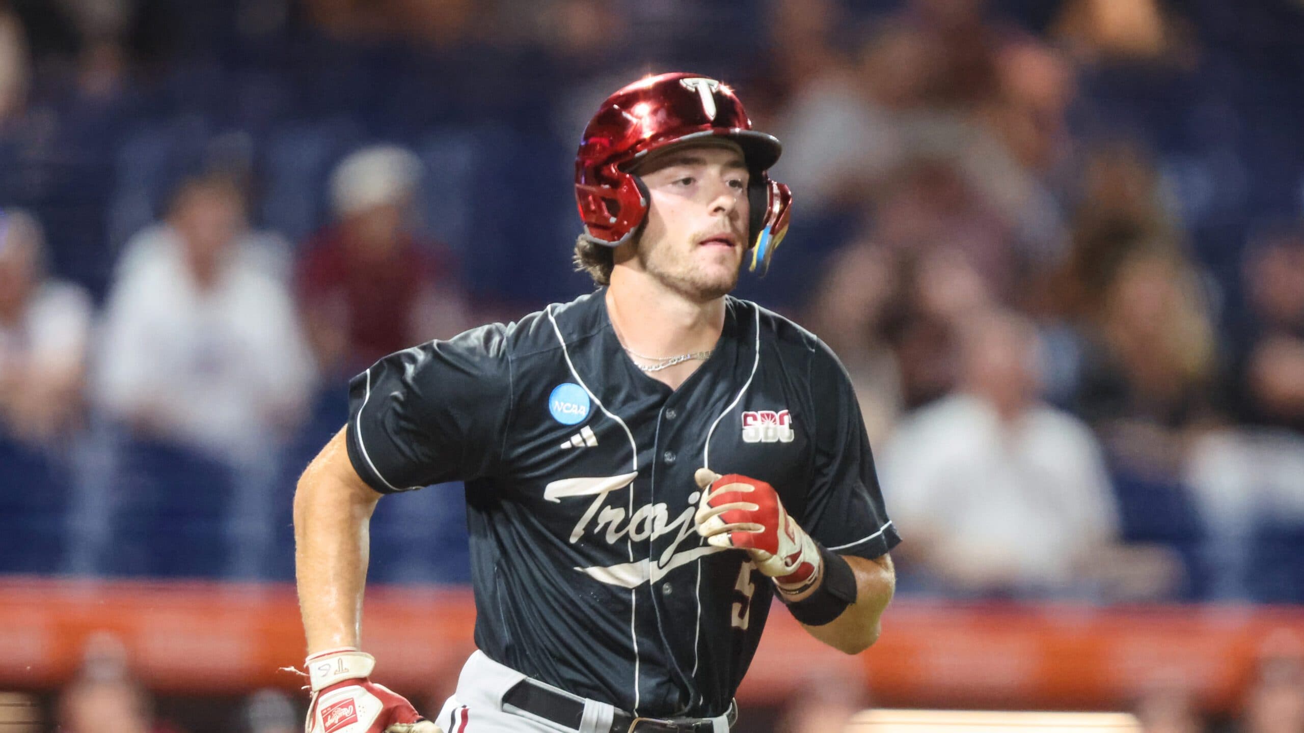 Troy catcher Jimmy Janicki (5) runs to first during an NCAA regional baseball game against Miami on Friday, May 29, 2026, in Gainesville, Fla. (AP Photo/Gary McCullough)