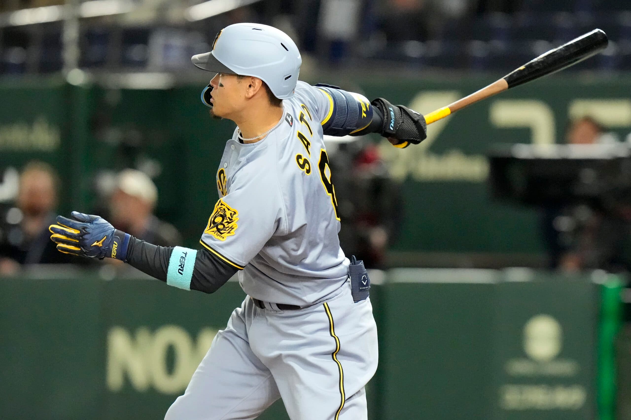 Hanshin Tigers' Teruaki Sato grounds out against the Chicago Cubs during the third inning of a spring training baseball game in Tokyo, Saturday, March 15, 2025. (AP Photo/Eugene Hoshiko)