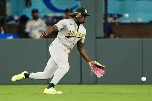 Athletics right fielder Lawrence Butler chases a triple hit boy Kansas City Royals' Miakel Garcia during the eighth inning of a baseball game Wednesday, Aug. 19, 2026, in Kansas City, Mo. (AP Photo/Charlie Riedel) (AP Photo/Charlie Riedel)