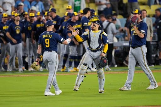 Milwaukee Brewers catcher William Contreras greets first baseman Jake Bauers (9) after Game 3 of baseball's National League Championship Series between the Milwaukee Brewers and the Los Angeles Dodgers, Wednesday, Oct. 14, 2026, in Los Angeles. (AP Photo/Mark J. Terrill) (AP Photo/Mark J. Terrill)