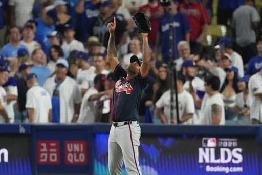 Atlanta Braves pitcher Raisel Iglesias celebrates after the Braves defeated the Los Angeles Dodgers 3-2 in Game 2 of a National League Division Series baseball game Sunday, Oct. 4, 2026, in Los Angeles. (AP Photo/Jae C. Hong) (AP Photo/Jae C. Hong)
