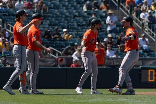 Baltimore Orioles' Gunnar Henderson, right, celebrates after hitting a three-run home run with Blaze Alexander, second from right, Pete Alonso, second from left, and Coby Mayo, left, during the fifth inning of a baseball game against the Athletics Sunday, Aug. 30, 2026, in West Sacramento, Calif. (AP Photo/Sara Nevis) (AP Photo/Sara Nevis)