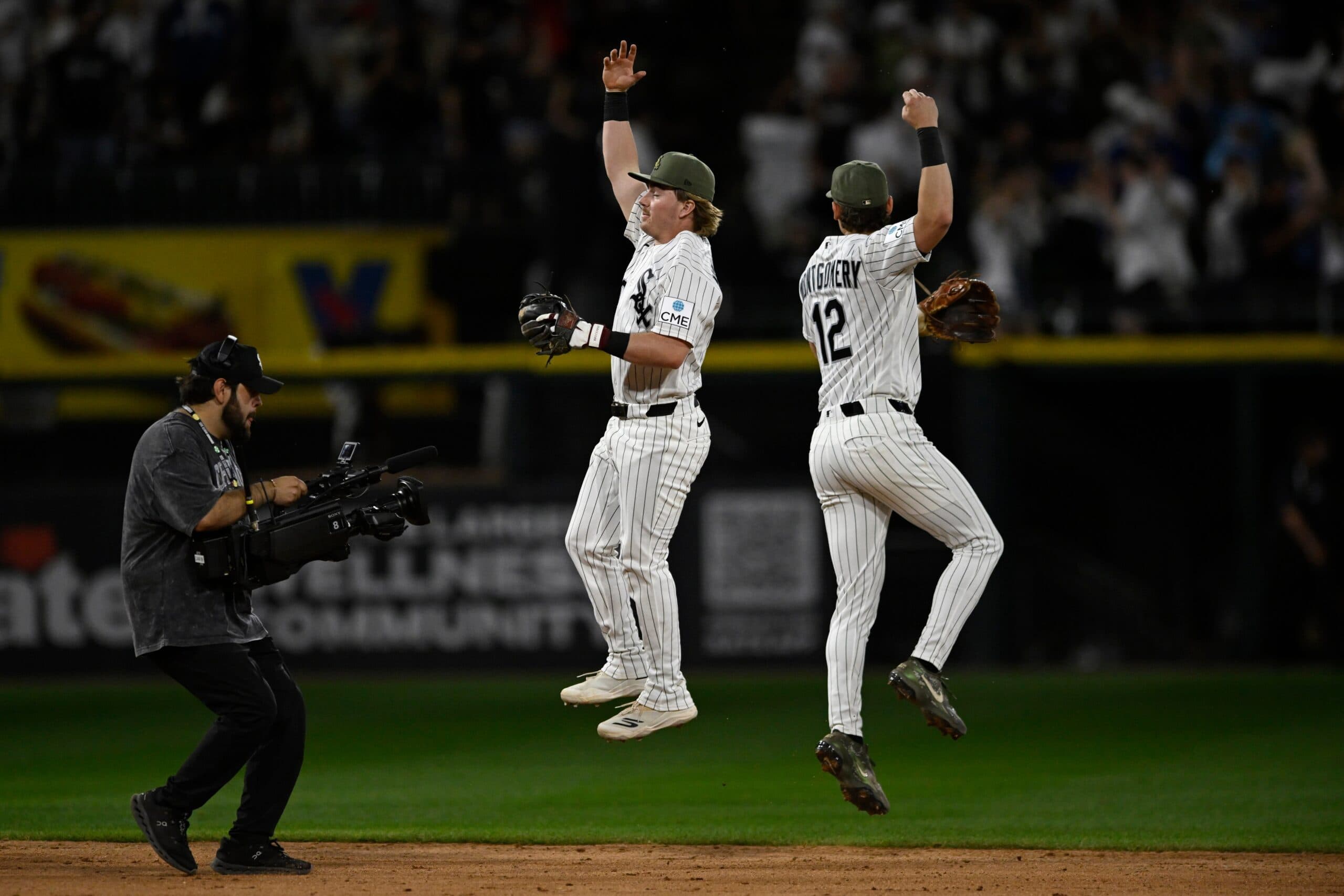 Chicago White Sox's Chase Meidroth, left, and Colson Montgomery (12) celebrate after defeating the Chicago Cubs in a baseball game in Chicago, Saturday, May 16, 2026. (AP Photo/Paul Beaty)
