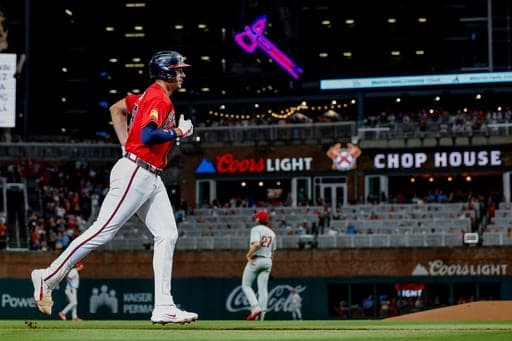 Atlanta Braves' Matt Olson, left, rounds the bases after hitting a solo home run against Philadelphia Phillies pitcher Aaron Nola during the first inning of a baseball game, Friday, Sept. 11, 2026, in Atlanta. (AP Photo/Erik S. Lesser) (AP Photo/Erik S. Lesser)