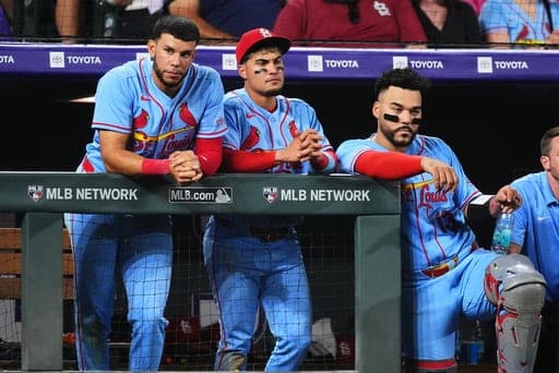 From left to right, St. Louis Cardinals left fielder Joshua Báez, second baseman Bryan Torres and catcher Leo Bernal look on in the ninth inning of a baseball game against the Colorado Rockies, Saturday, Sept. 5, 2026, in Denver. (AP Photo/David Zalubowski) (AP Photo/David Zalubowski)