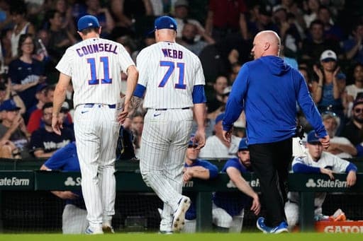 Chicago Cubs pitcher Jacob Webb (71) leaves with manager Craig Counsell, left, and a team trainer after an injury during the ninth inning of a baseball game against the Milwaukee Brewers in Chicago, Wednesday, Sept. 2, 2026. (AP Photo/Nam Y. Huh) (AP Photo/Nam Y. Huh)