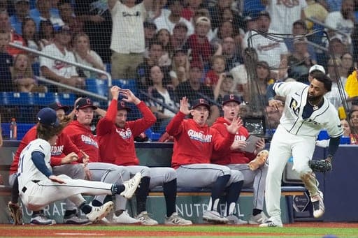 Tampa Bay Rays right fielder Jonny DeLuca and third baseman Junior Caminero collide try to catch a ball hit by Cleveland Guardians' Brayan Rocchio during the ninth inning in Game 1 of an American League Championship Series baseball game in St. Petersburg, Fla. Monday, Oct. 12, 2026. (AP Photo/David J. Phillip) (AP Photo/David J. Phillip)