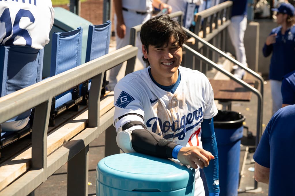 Los Angeles Dodgers' Shohei Ohtani smiles in the dugout during a baseball game against the Arizona Diamondbacks in Los Angeles, Sunday, Aug. 31, 2025. (AP Photo/Kyusung Gong)