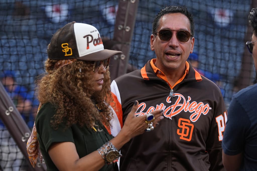 Padres owners José Feliciano and Kwanza Jones watch batting practice before Game 2 of the National League Wild Card Series.