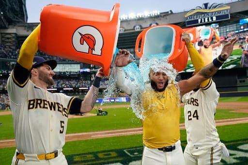 Milwaukee Brewers' Jackson Chourio is doused by Garrett Mitchell and William Contreras after hitting a walk-off hit during the ninth inning of Game 2 of a National League Divisional baseball playoff series against the San Diego Padres Sunday, Oct. 4, 2026, in Milwaukee. (AP Photo/Kayla Wolf) (AP Photo/Kayla Wolf)