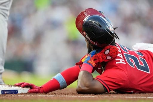 Atlanta Braves' Michael Harris II (23) dives back into first during the second inning in Game 3 of baseball's National League Division Series against the Los Angeles Dodgers, Tuesday, Oct. 6, 2026, in Atlanta. (AP Photo/Brynn Anderson) (AP Photo/Brynn Anderson)