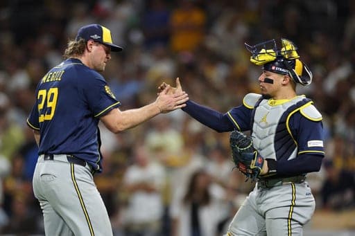 Milwaukee Brewers pitcher Trevor Megill (29) and catcher William Contreras (24) celebrate after the team defeated the San Diego Padres in Game 4 of baseball's National League Division Series Wednesday, Oct. 7, 2026, in San Diego. (AP Photo/Derrick Tuskan) (AP Photo/Derrick Tuskan)