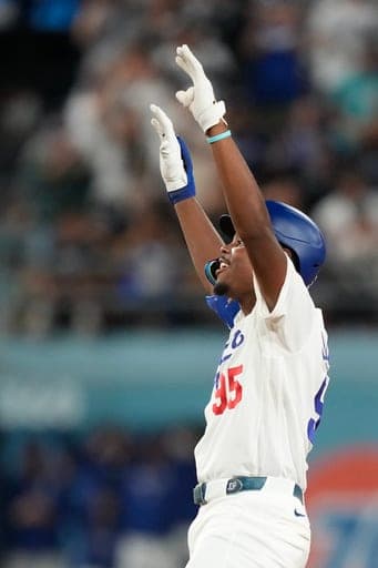 Los Angeles Dodgers' Josue de Paula gestures after hitting an RBI double during the sixth inning of a baseball game against the San Francisco Giants, Friday, Sept. 18, 2026, in Los Angeles. (AP Photo/Mark J. Terrill) (AP Photo/Mark J. Terrill)
