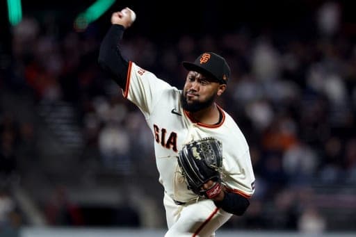 San Francisco Giants pitcher Dylan Smith throws against the Cincinnati Reds during the ninth inning of a baseball game in San Francisco, Monday, Aug. 24, 2026. (AP Photo/Jed Jacobsohn) (AP Photo/Jed Jacobsohn)