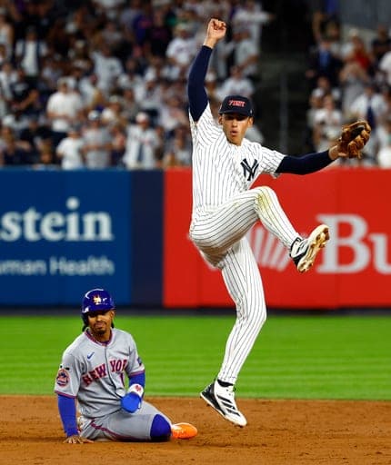 New York Mets' Francisco Lindor, left, reacts as New York Yankees shortstop George Lombard Jr., right, completes a game ending double play in the ninth inning of a baseball game, Friday, Sept. 11, 2026, in New York. (AP Photo/Noah K. Murray) (AP Photo/Noah K. Murray)
