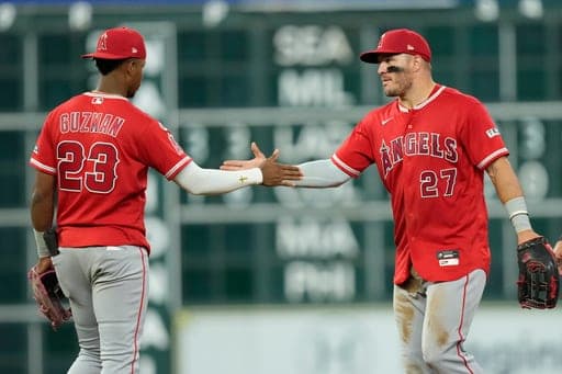 Los Angeles Angels' Denzer Guzman (23) and Mike Trout (27) celebrate after a baseball game against the Houston Astros Tuesday, Aug. 18, 2026, in Houston. (AP Photo/David J. Phillip) (AP Photo/David J. Phillip)
